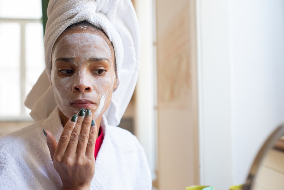 Best Face Washes for Seborrheic Dermatitis 2023: Top 10 Choices - Woman applying face cream in bathroom, part of her daily skincare routine.