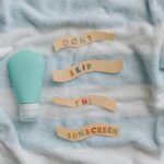 Best Sunscreen for Seborrheic Dermatitis: Safe SPF That Won't Trigger Flare-Ups (2026) - Flat lay of sunscreen bottle with message 'Don't skip the sunscreen' on a towel.