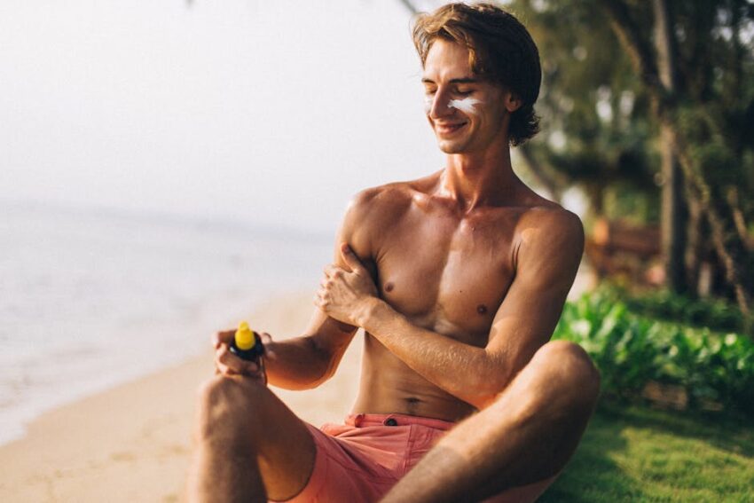 Best Sunscreens for Seborrheic Dermatitis 2026: Top 10 Picks for Sensitive Skin - Adult man applies sunscreen on sunny beach, enjoying summer vacation.
