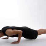 Can Exercise Help Prevent Seborrheic Dermatitis? What the 2026 Research Shows - Young man in athletic wear doing push-ups, showcasing strength and fitness.