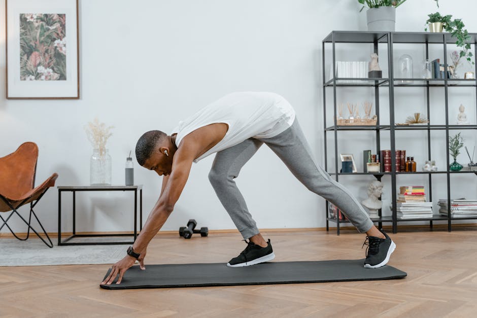 Can Exercise Help Prevent Seborrheic Dermatitis? What the 2026 Research Shows - Adult black man stretching on yoga mat indoors, embracing fitness and healthy lifestyle.