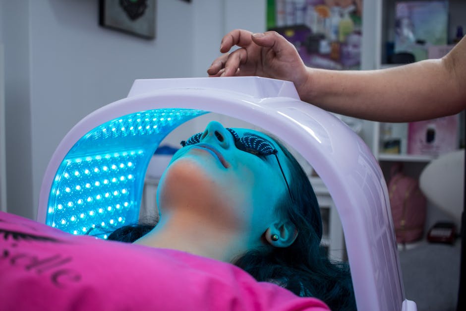 Discover Effective Phototherapy Techniques for Seborrheic Dermatitis - Unrecognizable woman with dark hair with pierced ears lying under ultraviolet lamp while visiting contemporary clinic and spending time in modern salon