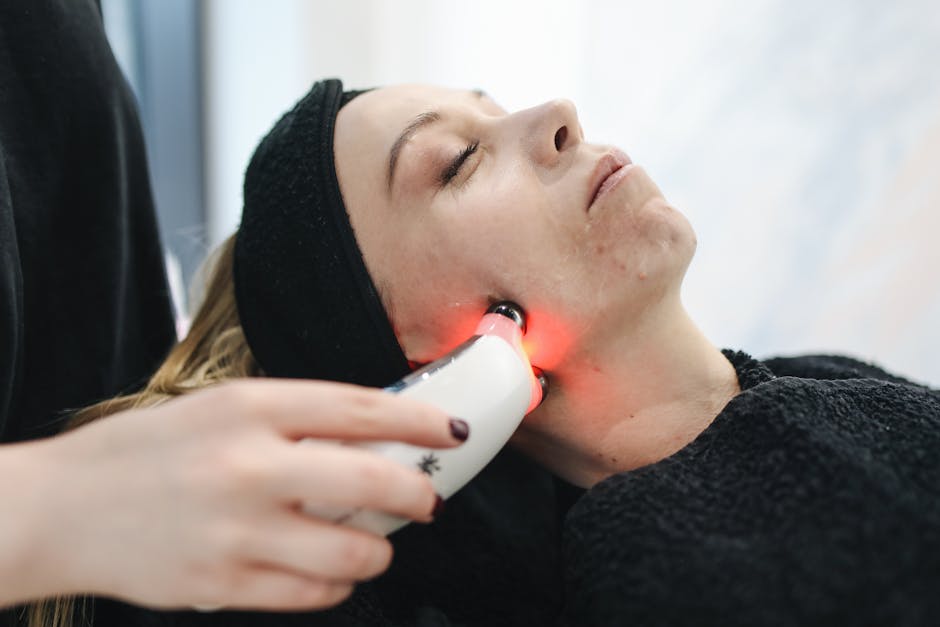 Discover Effective Phototherapy Techniques for Seborrheic Dermatitis - An adult woman receives a laser facial treatment in a modern skincare clinic.