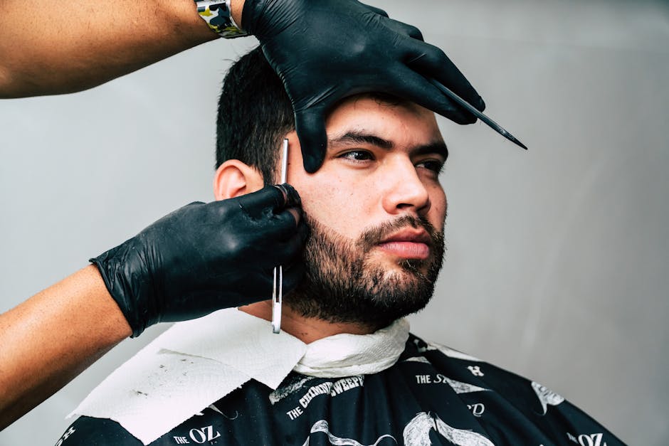 MCT Oil for Seborrheic Dermatitis: Why Malassezia-Safe Moisturizing Works (2026) - Man receiving a precise beard trim in a barbershop, showcasing expert grooming skills.
