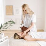 Ocean Swimming with Seborrheic Dermatitis: What Salt Water Actually Does to Your Skin (2026) - Aesthetician performing a facial treatment on a client in a serene spa clinic.