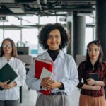 Salicylic Acid for Seborrheic Dermatitis: Does It Work? (2026 Guide) - Three professional women standing confidently in a modern office environment, showcasing diversity.