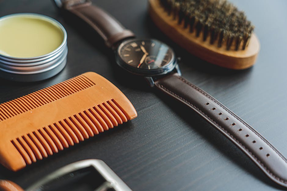 Seborrheic Dermatitis and Curly Hair: Scalp Care Guide for Tight Coils and Waves (2026) - Flat lay image of grooming items with an elegant leather wristwatch on a dark surface.