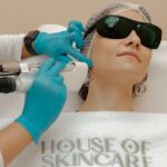 Seborrheic Dermatitis and Ocean Swimming: Is Salt Water Good or Bad? - A woman receiving a laser skincare treatment in a beauty clinic.