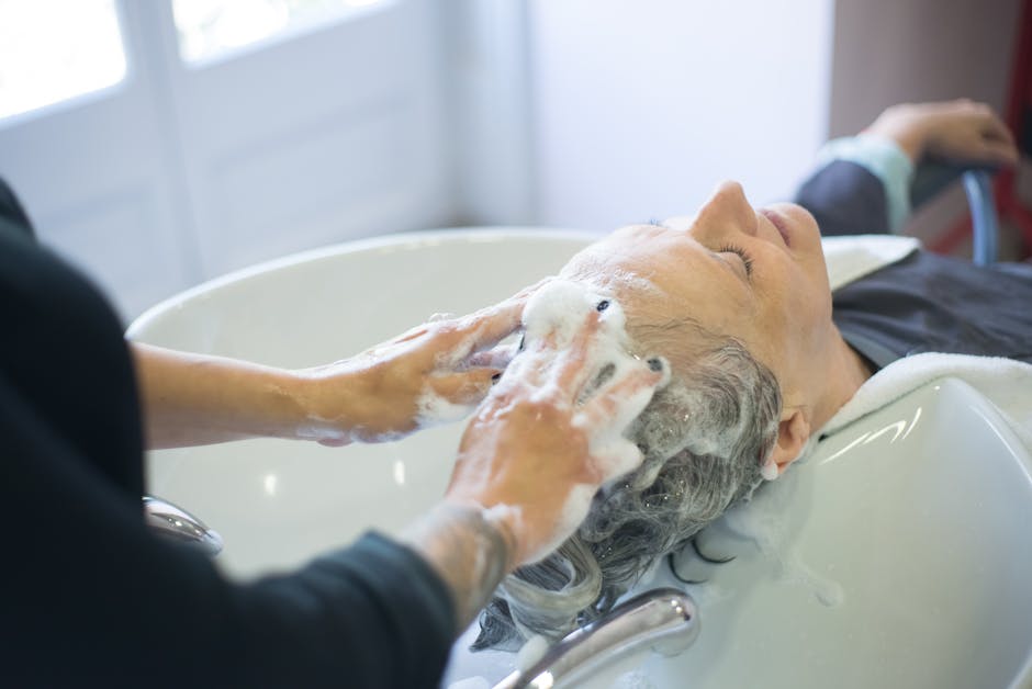Seborrheic Dermatitis and Scalp Buildup: Your Complete Guide to a Healthy Scalp - Close-up of senior woman getting hair washed with foam at salon sink, enjoying the pampering session.