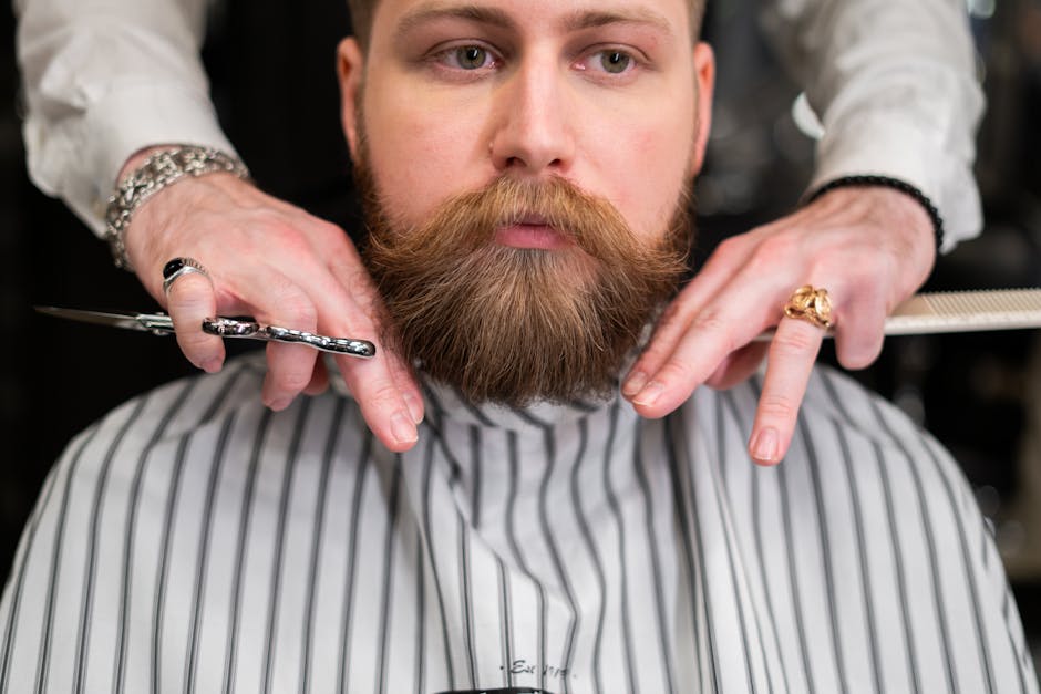 Seborrheic Dermatitis Beard Treatment Guide 2026: How to Manage Flaking, Itching & Redness Under Facial Hair - A stylish bearded man receiving precision grooming at a barbershop.