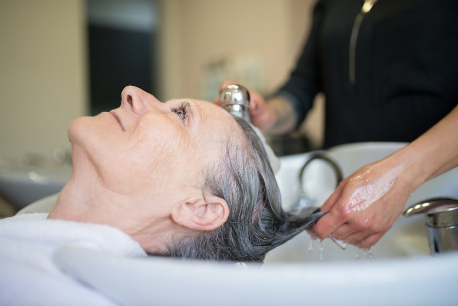Seborrheic Dermatitis Hair Loss Treatment & Regrowth Guide 2026: Effective Solutions 19 Seborrheic Dermatitis Hair Loss Treatment & Regrowth Guide 2026: Effective Solutions - Elderly woman enjoying a relaxing hair wash session in a professional salon setting.