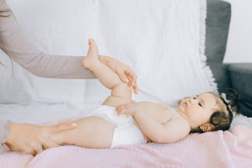 Seborrheic Dermatitis in Infants 27 Seborrheic Dermatitis in Infants - A tender moment with a baby receiving a gentle massage on a bed.
