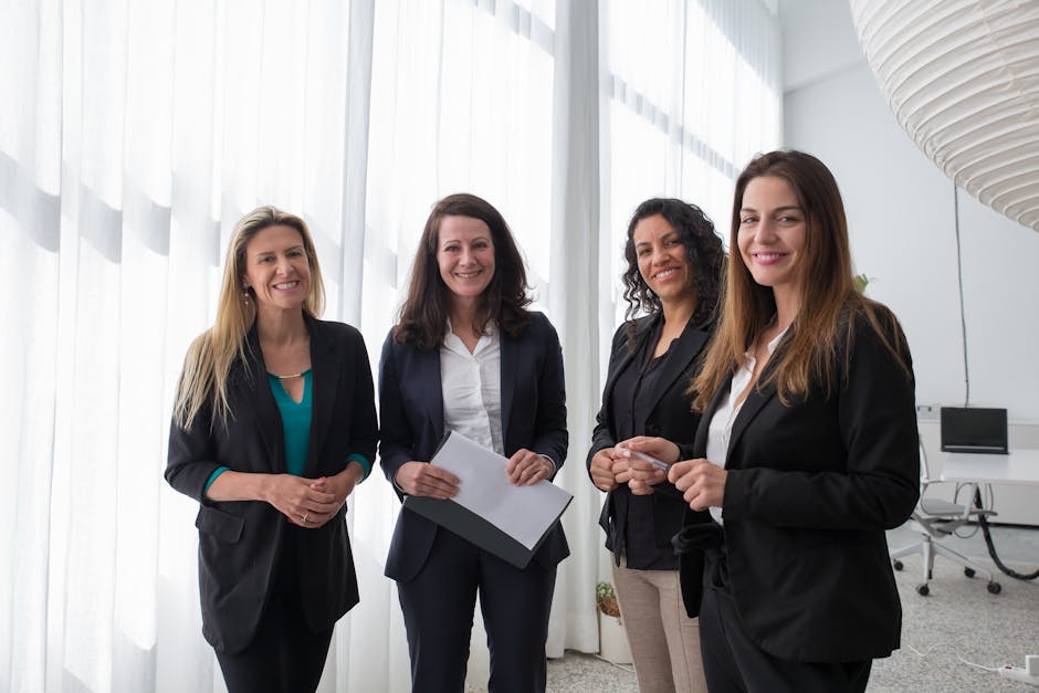 Sulfur for Seborrheic Dermatitis: Does This Classic Treatment Still Work? (2026 Guide) - Four professional women in business attire smiling in a bright, modern office.