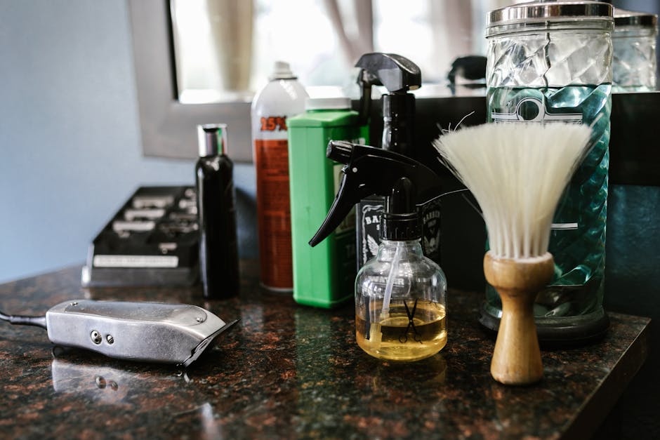 Tea Tree Oil for Seborrheic Dermatitis: Does It Work? Evidence-Based Guide 2026 6 Tea Tree Oil for Seborrheic Dermatitis: Does It Work? Evidence-Based Guide 2026 - Close-up of barber tools on counter including clippers, spray bottle, and brush in a stylish barbershop.