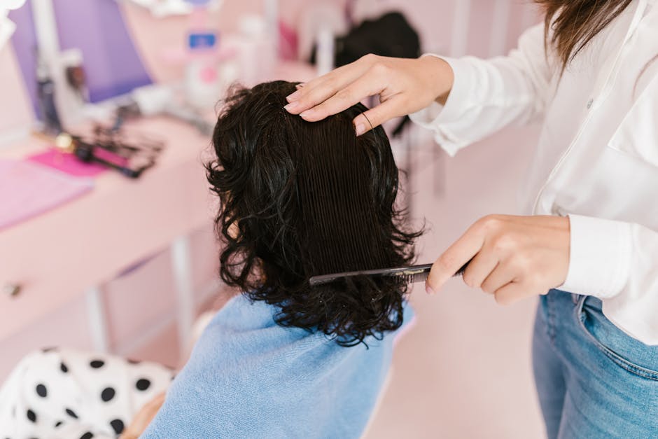 The 10 Best Seborrheic Dermatitis Hair Styling Products: Finding the Right Products for Your Hair Type - Close-up of a woman receiving hairstyling treatment in a contemporary salon.
