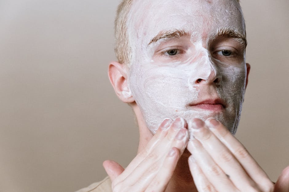 The Ultimate Guide to Treating Seborrheic Dermatitis: Find Your Perfect Face Wash - Close-up of a man applying facial cleanser for a refreshing skincare routine, focusing on self-care and health.