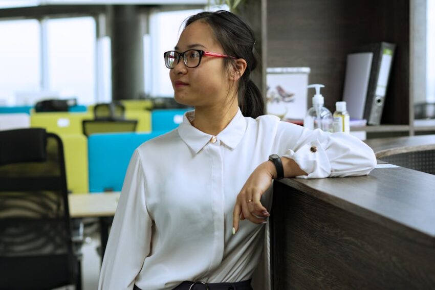 Zinc Pyrithione Soap for Seborrheic Dermatitis: Does It Work? (2026 Guide) - Side view of an Asian woman in a modern office environment, displaying professional demeanor.