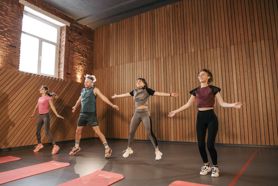 Can Exercise Help Prevent Seborrheic Dermatitis? 2026 Research - Group of adults doing jumping jacks in modern gym interior.