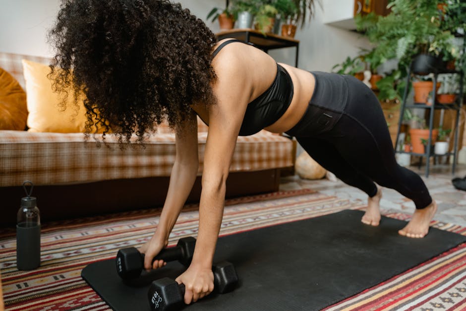 Can Exercise Prevent Seborrheic Dermatitis? What 2026 Research Shows - Woman performing push-ups with dumbbells on yoga mat in cozy indoor setting.