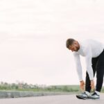 Can Exercise Prevent Seborrheic Dermatitis? What 2026 Research Reveals - Healthy lifestyle concept with a man stretching outside in activewear, preparing for exercise.
