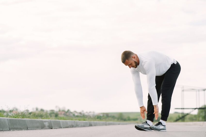 Can Exercise Prevent Seborrheic Dermatitis? What 2026 Research Reveals - Healthy lifestyle concept with a man stretching outside in activewear, preparing for exercise.