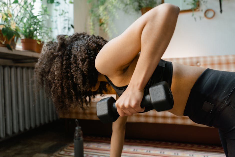 Can Exercise Prevent Seborrheic Dermatitis? What 2026 Research Shows - African American woman working out with dumbbells in an indoor setting, promoting a healthy lifestyle.