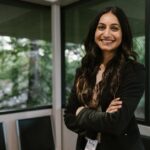 Do Antihistamines Work for Seb Derm? 2026 - Smiling woman in business attire stands confidently in a modern office with large windows.
