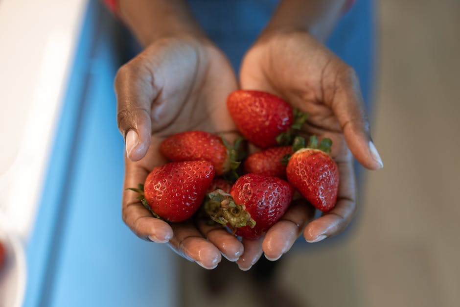 Malassezia-Safe Diet for Seborrheic Dermatitis: What the Fat Science Actually Shows (2026) - A close-up image of hands gently holding ripe strawberries, showcasing freshness.