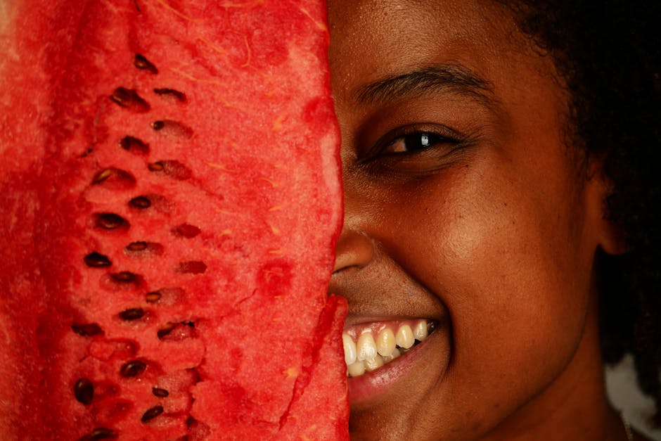 malassezia-safe-diet-seborrheic-dermatitis - A cheerful person holding a watermelon slice close to the face, showcasing a joyful expression.