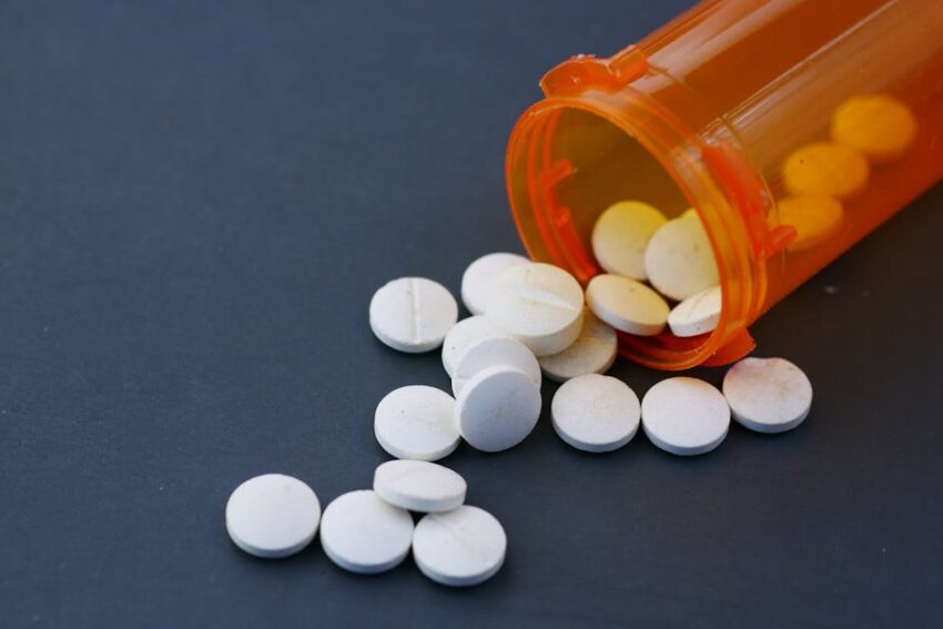 Non-Steroidal Topicals for Seborrheic Dermatitis: What 2026 Evidence Shows - Close-up of white pills scattered from an orange prescription bottle on a gray surface.