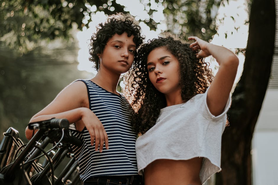 seb-derm-myths-debunked-2026 - Two stylish friends with curly hair posing confidently outdoors, showcasing togetherness and modern fashion.