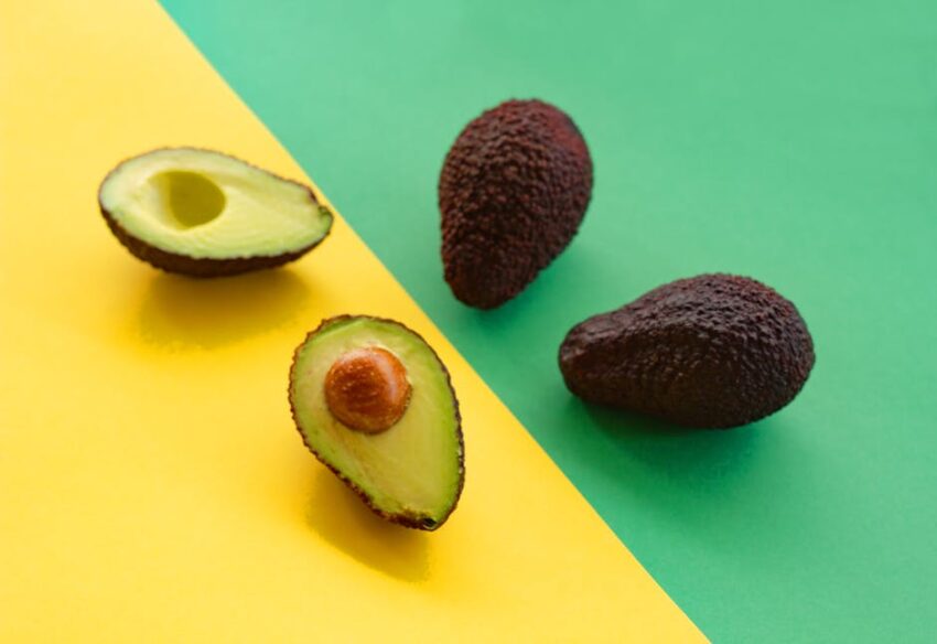 seborrheic-dermatitis-diet-foods-elimination-guide-2026 - Ripe avocados displayed on a vibrant yellow and green background, perfect for food-related designs.