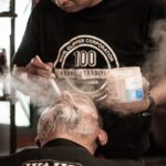 seborrheic-dermatitis-hair-loss-treatment-regrowth-2026-final - Close-up of a relaxed man receiving beard care in a traditional barbershop setting.