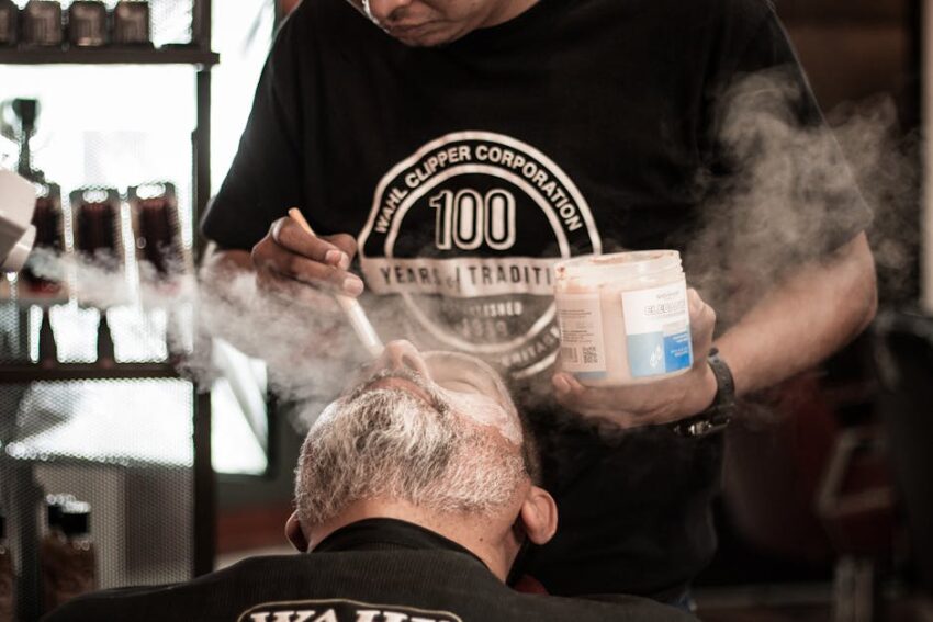 seborrheic-dermatitis-hair-loss-treatment-regrowth-2026-final - Close-up of a relaxed man receiving beard care in a traditional barbershop setting.