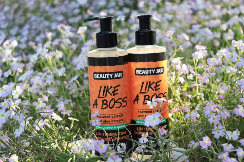 Seborrheic Dermatitis or Dry Scalp? How to Tell the Difference Before You Buy Another Shampoo (2026) - Beauty Jar 'Like a Boss' shampoo bottles surrounded by vibrant wildflowers, capturing freshness and nature's energy.