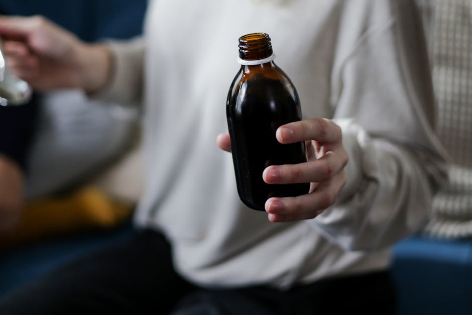 Seborrheic Dermatitis or Dry Scalp? How to Tell the Difference Before You Buy Another Shampoo - Close view of a person holding an amber medicine bottle, signifying health care and treatment.