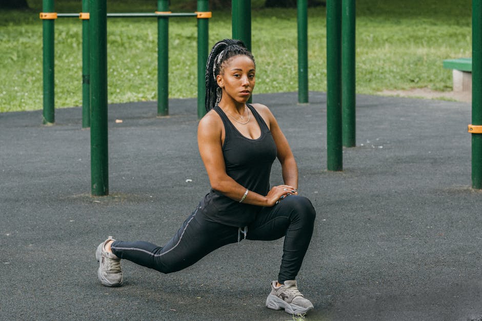 sweat-wicking-products-seborrheic-dermatitis-summer-2026 - Athletic woman in activewear stretching outdoors in a park for fitness.
